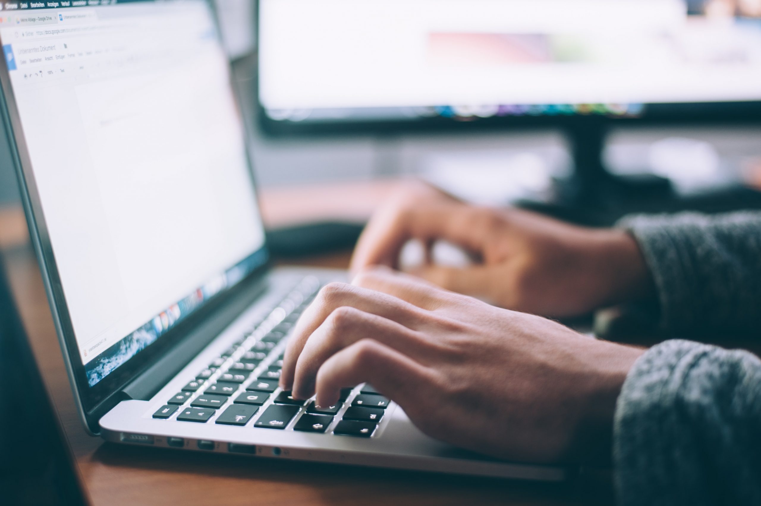 Photo of person typing on laptop