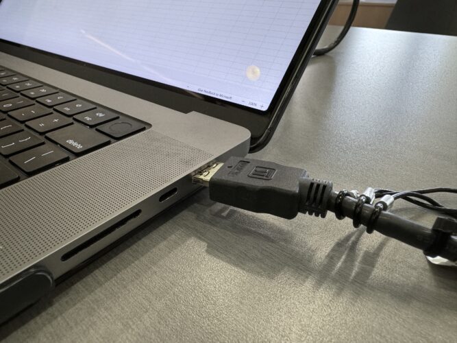 Photo of an HDMI cable connecting to a laptop